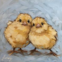 two little chicks sitting on top of each other in front of a blue sky background