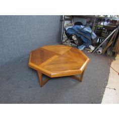 a wooden table sitting on top of a carpeted floor