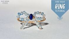 a ring with blue and white beads on it sitting on top of a white surface