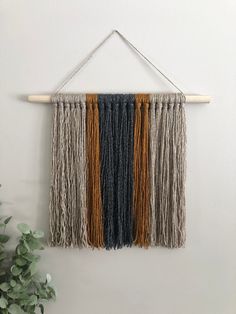 the wall hanging is decorated with multicolored fringes