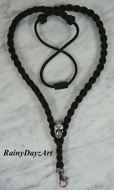 A paracord ID lanyard/badge holder made with a high quality 304 stainless steel skull bead, seven strand 550 heavy duty paracord, silver tone lobster clasp clip and finished with a quick release barrel connector. How to measure for your new lanyard: To measure for your new lanyard go around your neck with a cloth measuring tape and where you would like the inside V of the lanyard to sit on your torso that is your measurement. If your dont have a cloth measuring tape you can use a string and when Lanyard Badge Holder, Paracord Dog Leash, Nurse Lanyard, Service Dogs Gear, Dslr Camera Straps, Lanyard Teacher, Id Lanyard, Tumbler Handle, Skull Gifts