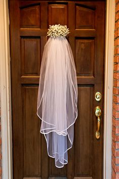 a bride's veil hanging on the front door