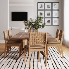 a dining room table with chairs and a rug