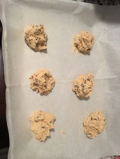 six cookies on a baking sheet ready to go into the oven