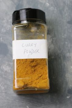 a jar filled with curry powder sitting on top of a table