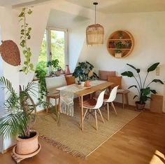 a living room filled with furniture and plants