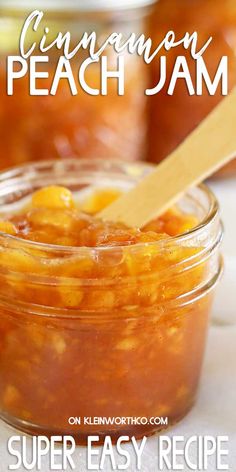 a jar filled with peach jam on top of a table