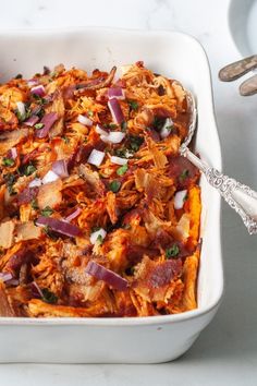 a casserole dish with meat and onions in it