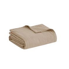 the linen blanket is folded on top of each other, with two sheets folded over it