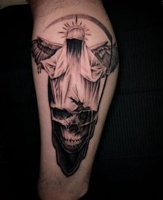 a man's leg with a tattoo on it and a skull in the middle