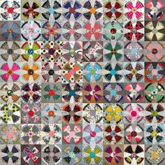 a large quilt with many different designs on it's sides, including circles and squares