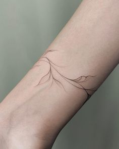 a woman's arm with a small tattoo on the left side of her arm