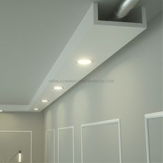 an empty room with white walls and recess lights on the ceiling is pictured in this image