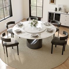 a round table with chairs around it in a room