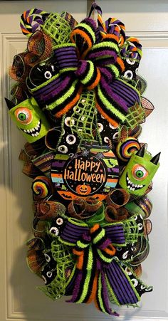 a halloween wreath hanging on the front door