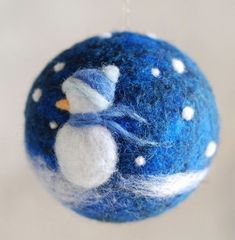 a blue and white ornament with snowmen on it