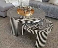 three tables with black and white stripes on them in front of a couch, coffee table