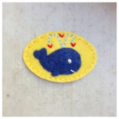 a blue and yellow whale with hearts on it