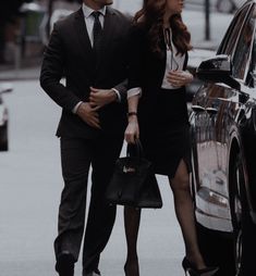 a man and woman walking down the street