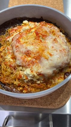 a casserole dish with meat and cheese in it