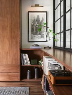 the bookshelf is filled with vinyl records and record players, as well as plants