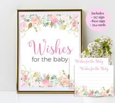 a baby shower sign, note cards and vase with flowers on the shelf next to it