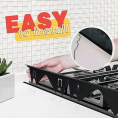 a stove top with an easy to install sign above it and a hand reaching for the burner