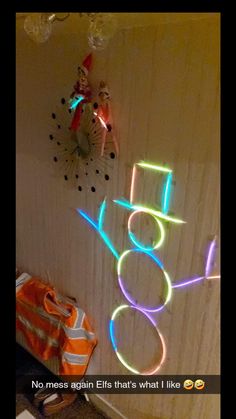 a neon sign that is on the wall next to a bag and some other items