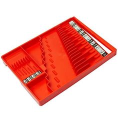 an orange plastic tray with dividers and scissors in it, on a white background