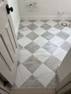 a bathroom with white and gray tile flooring