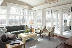 a living room filled with furniture and lots of windows