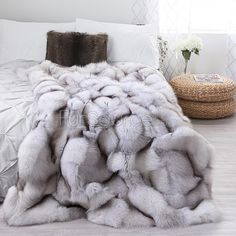 a bed with white and grey fur on it