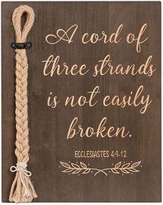 a wooden plaque with a rope that says,'a cord of three strands is not easily