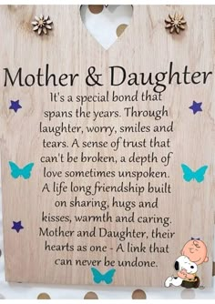 a wooden plaque with the words mother and daughter written on it, surrounded by butterflies