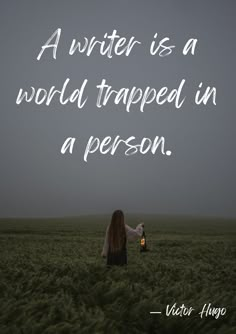 a woman standing in a field holding a lantern with the caption, a writer is a world trapped in a person