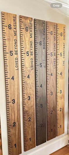 three wooden rulers are hanging on the wall