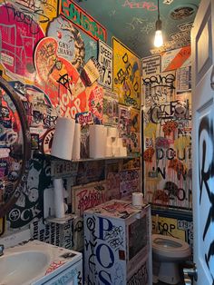 a bathroom with lots of graffiti on the walls and ceiling, along with a toilet