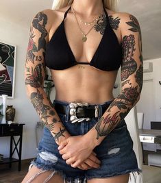 a woman with tattoos on her arms and chest