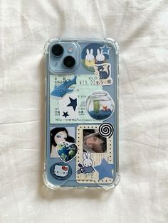 an iphone case with various pictures and stickers attached to it on a white sheet