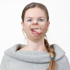 a woman making a funny face with her tongue sticking out and looking at the camera