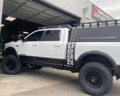 a white truck parked in front of a building