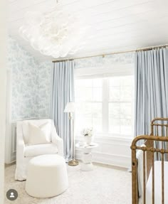 a baby's room with blue and white wallpaper