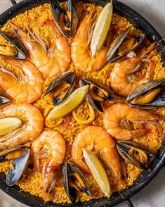 a pan filled with cooked shrimp and mussels