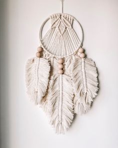 a white dream catcher hanging on the wall