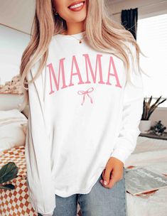 Embrace motherhood in style with the Coquette Mama long sleeve shirt- a perfect blend of comfort and coquettish charm, ideal for moms and expecting mothers. This girly mama crewneck, coupled with a coquette bow , makes an exquisite Mother's Day or baby shower gift, celebrating the journey of pregnancy with elegance. Shop now to gift the special mom in your life a touch of sweetness and warmth. 👕 PRODUCT INFO Made with 100% ring-spun cotton, these long-sleeve unisex shirts come packed with softn Mama Crewneck, Shirt Coquette, Bow Shirt, Bow Shirts, Coquette Bow, Pregnancy Gifts, Baby Mama, Matching Shirts, Unisex Shirts