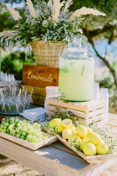 a table with lemonade and grapes on it