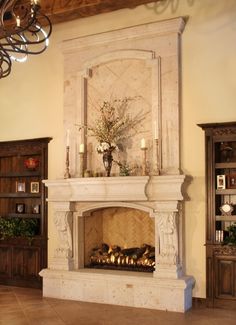 a living room with a fireplace and chandelier