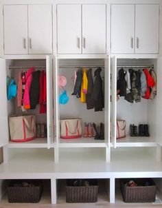 a white closet filled with lots of clothes and bags