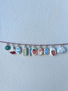 a string with charms hanging from it on a wall