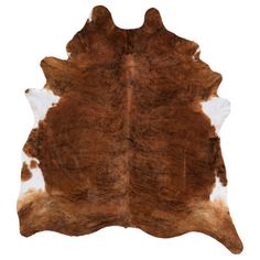 a brown and white cowhide rug on a white background